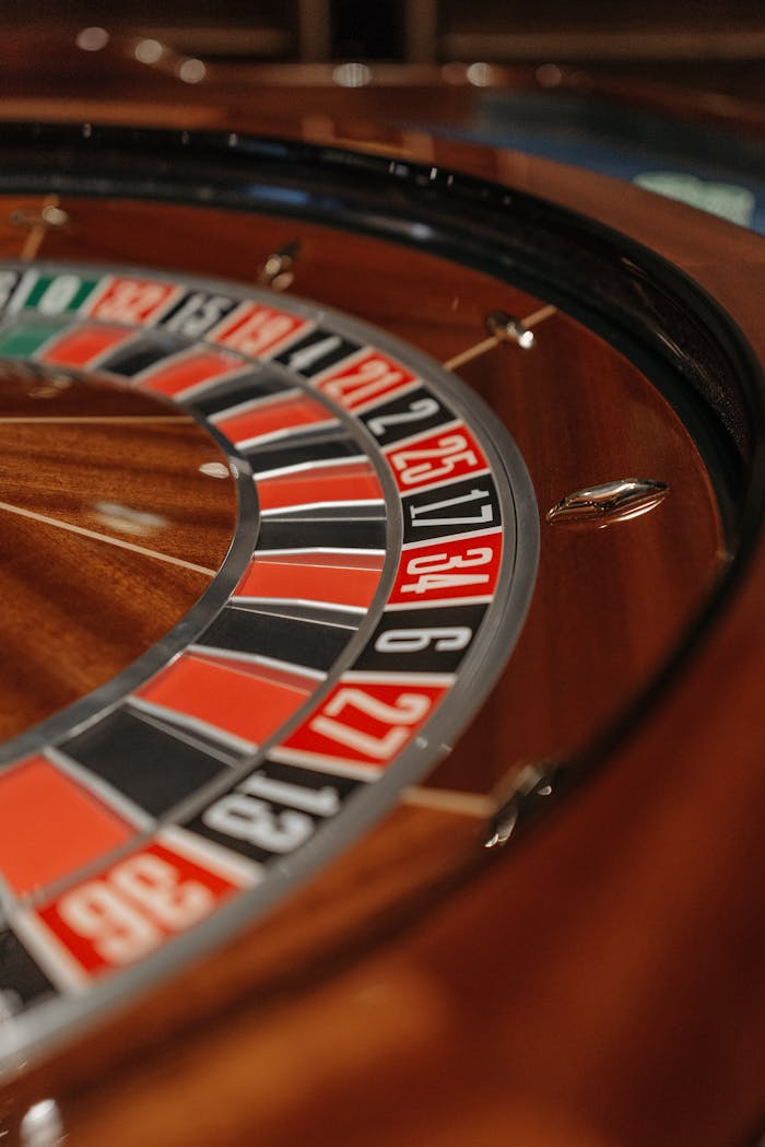 Detailed close-up of a roulette wheel in a casino, focusing on numbers and colors.